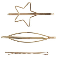 Drei goldfarbene Haarspangen aus Metall in unterschiedlichen Formen wie Stern und Linien.
