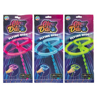 Leuchtende Flugscheibe mit Leuchteffekt und Startmechanismus in den Neonfarben Blau, Pink und Grün.